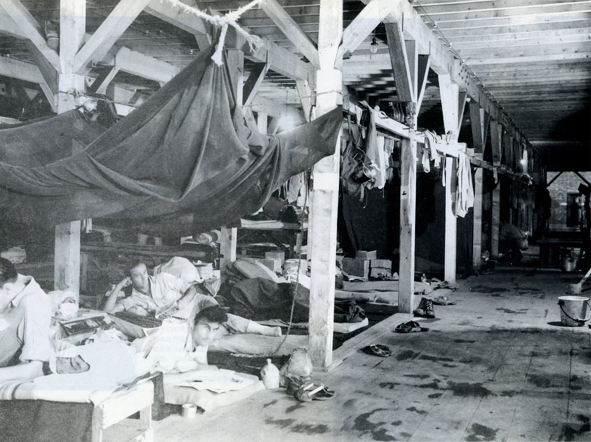 Inside the POW camp barracks%2c there were 8 people using each bunk at the time - small