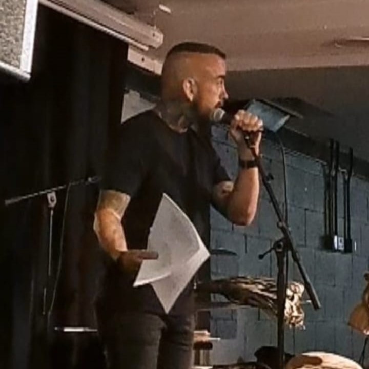 Image of Steve onstage performing poetry.