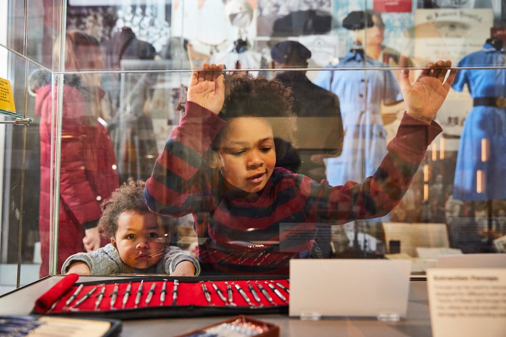 Image of two children looking at medical equipment.