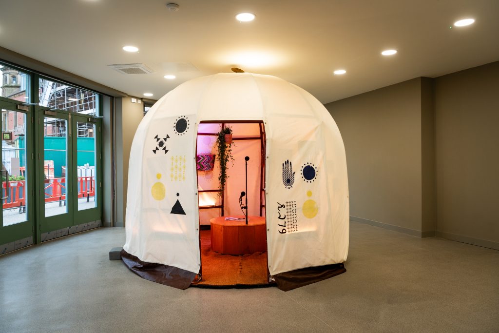 Image of the installation from the outside, with Somali symbols framing the doorway.