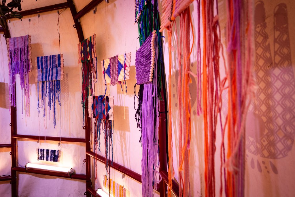 Image taken from one of the inside walls of the aqal showing a panoramic view of several tapestries.