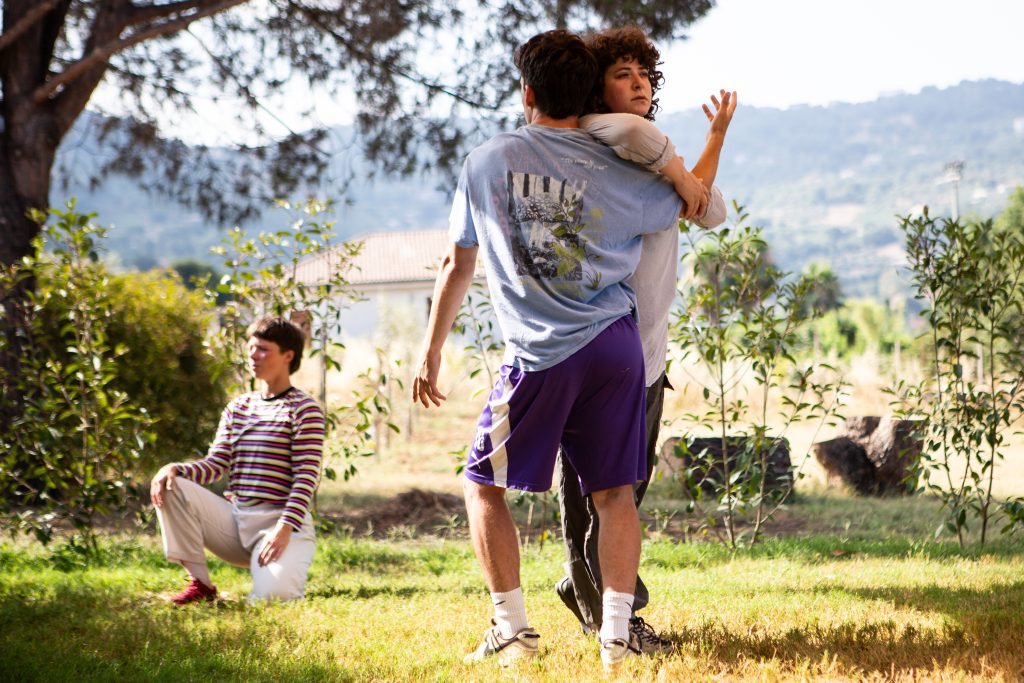 Image of two people in a field dancing.