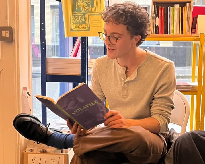 Tom Branfoot sits in a bookshop reading 'Volatile'.