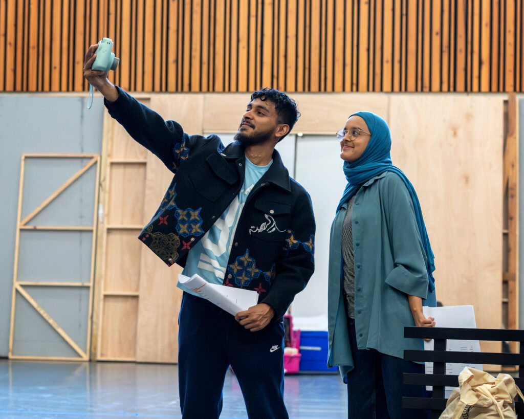 Humera Syed (Hafsah) smiles as Kashif Ghole (Bilal) takes of selfie of them together.