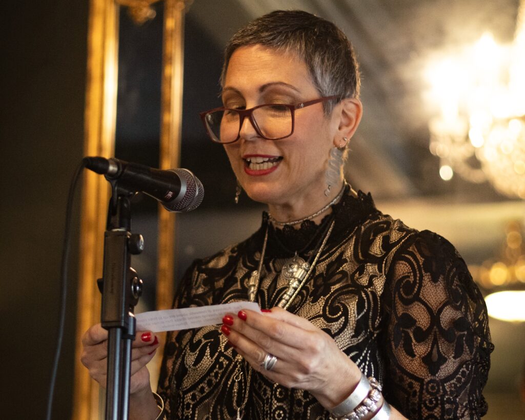 Sarah Rooke reads from a piece of paper during the That’s What She Said poetry event at The Cardigan Arms in Leeds.